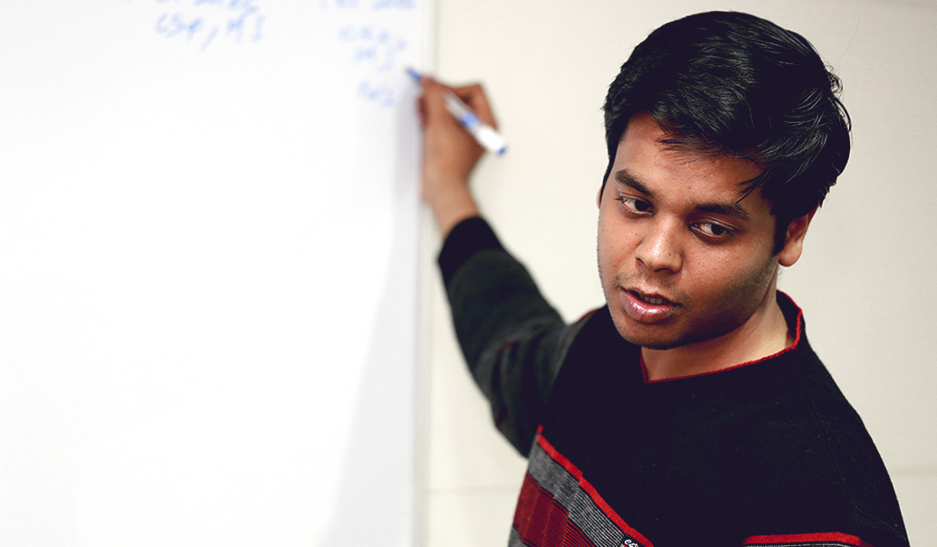 Man writing on dry erase board