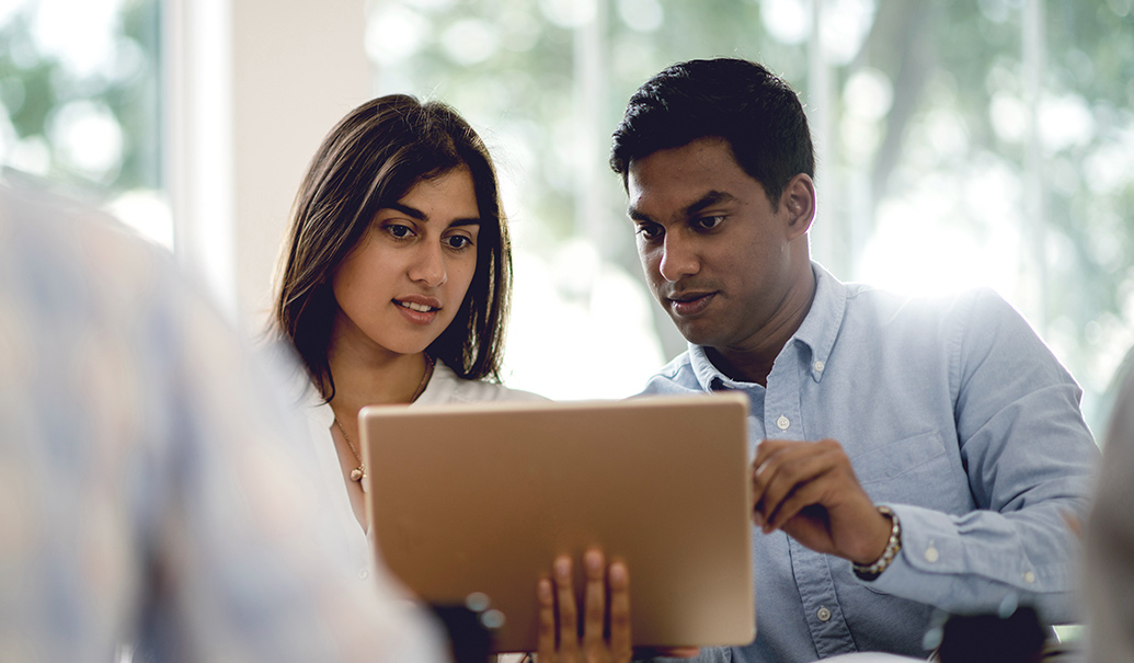 Two people looking at tablet